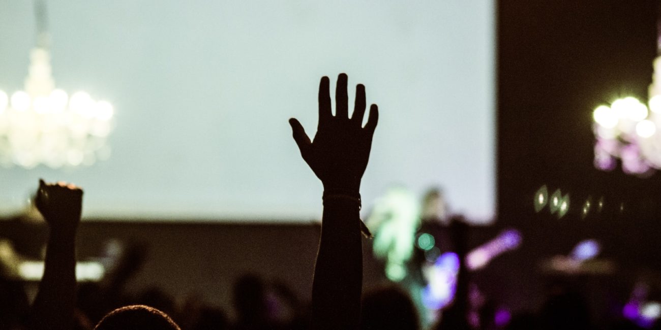 silhouette photography of human hand raising